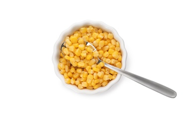 Photo of Bowl and spoon with corn kernels on white background, top view