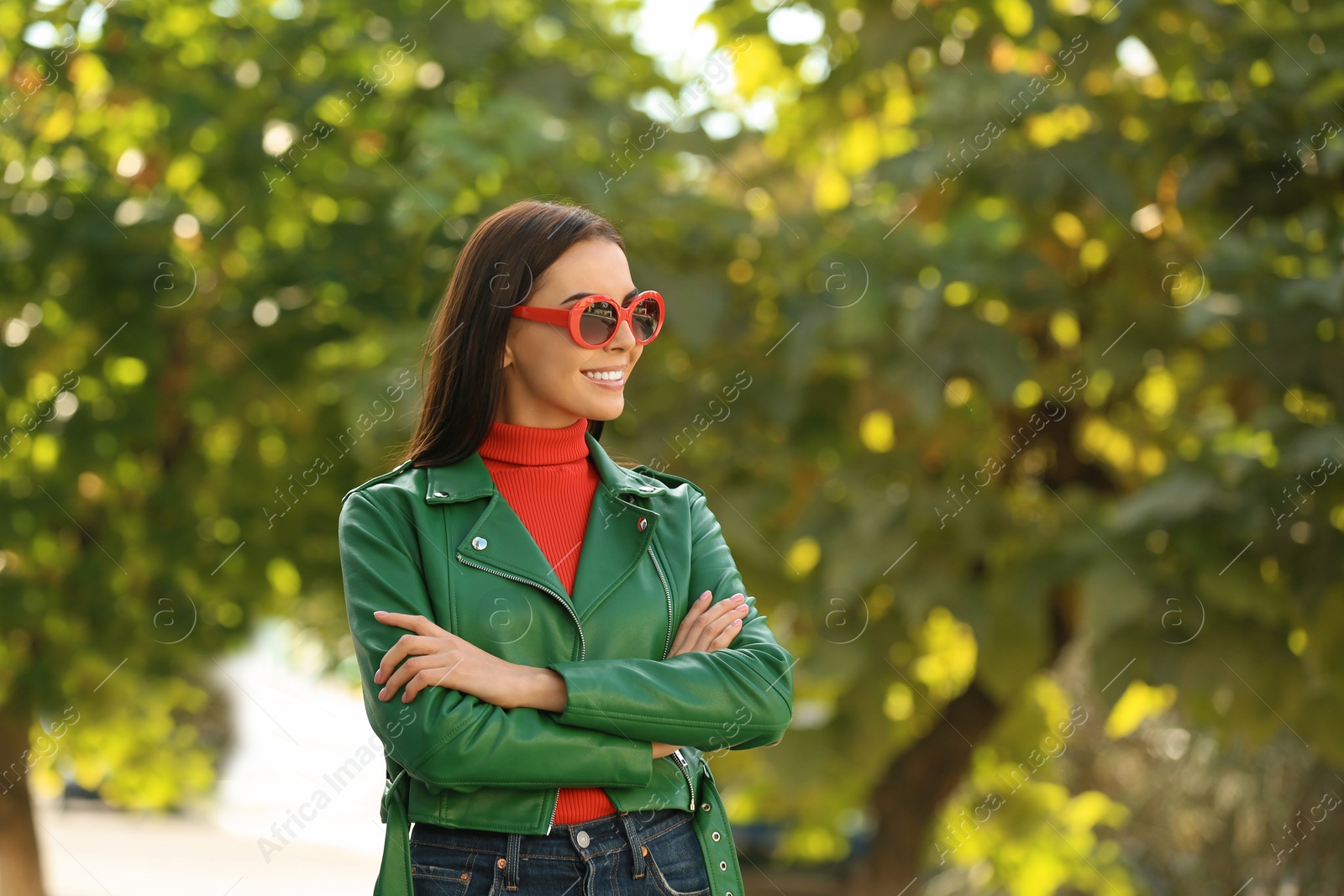 Photo of Beautiful woman wearing red sunglasses in green park