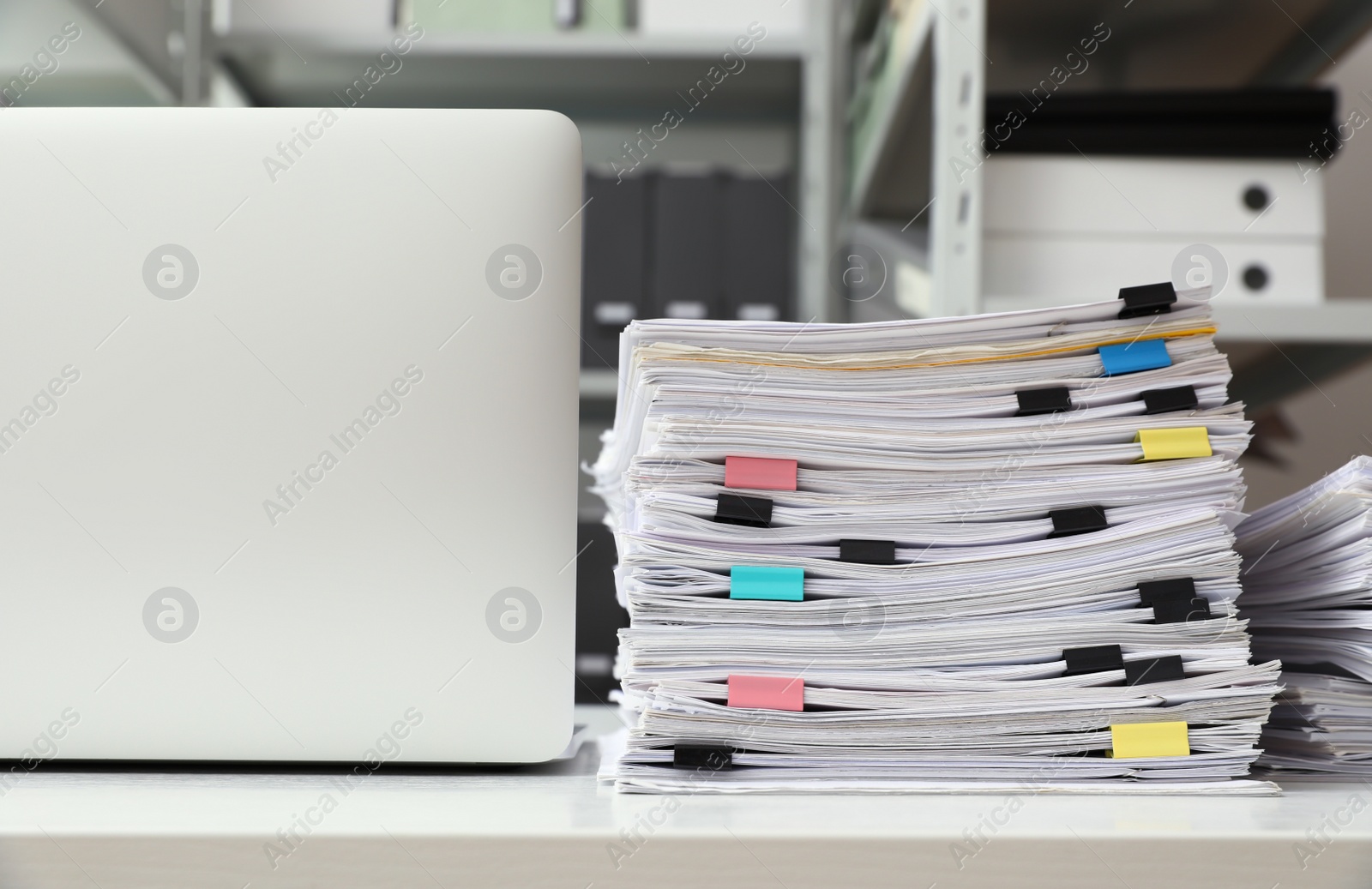 Photo of Laptop and documents on desk in office