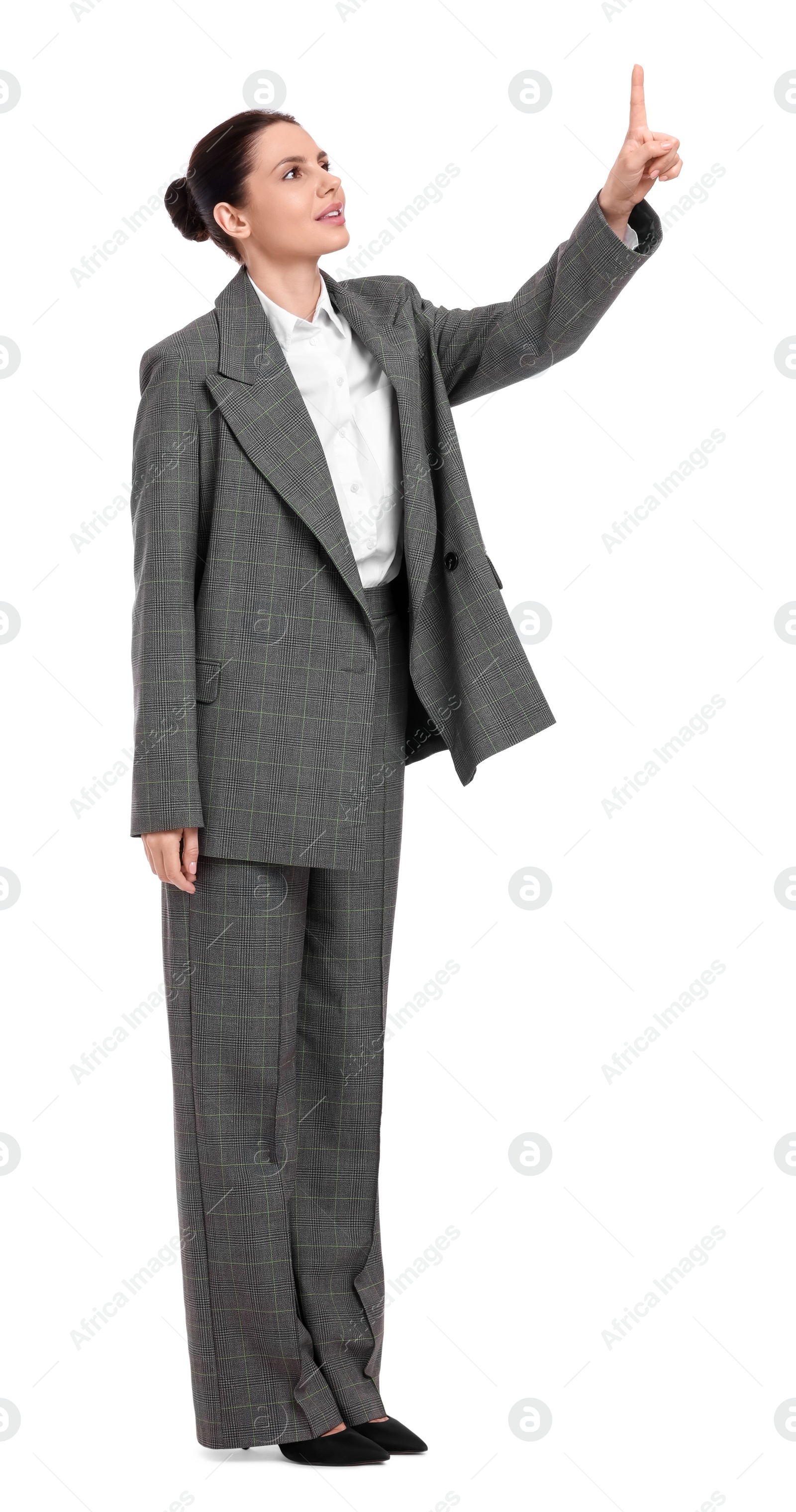 Photo of Beautiful businesswoman in suit pointing at something on white background