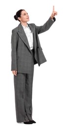 Beautiful businesswoman in suit pointing at something on white background