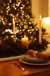 Photo of Luxury place setting with beautiful festive decor for Christmas dinner on wooden table