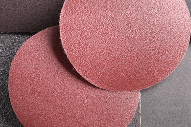 Photo of Many sheets of sandpaper as background, top view