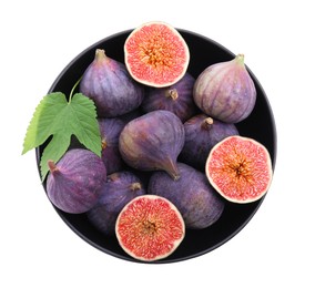 Whole and cut fresh purple figs in bowl isolated on white, top view