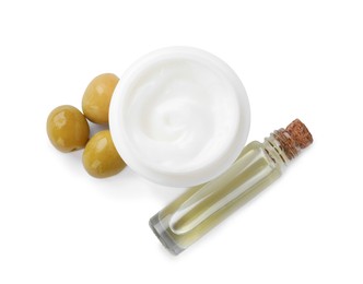 Photo of Body cream and cosmetic product with olives on white background, top view