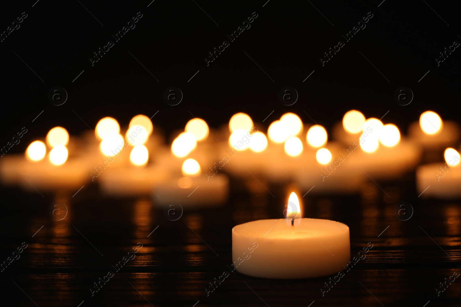 Photo of Burning candle on table, space for text