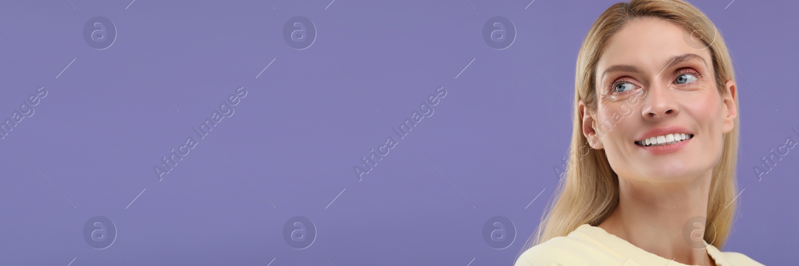 Image of Woman with clean teeth smiling on violet background, space for text. Banner design