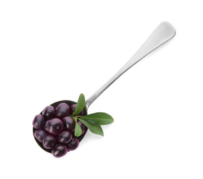 Fresh acai berries in wooden spoon isolated on white, top view