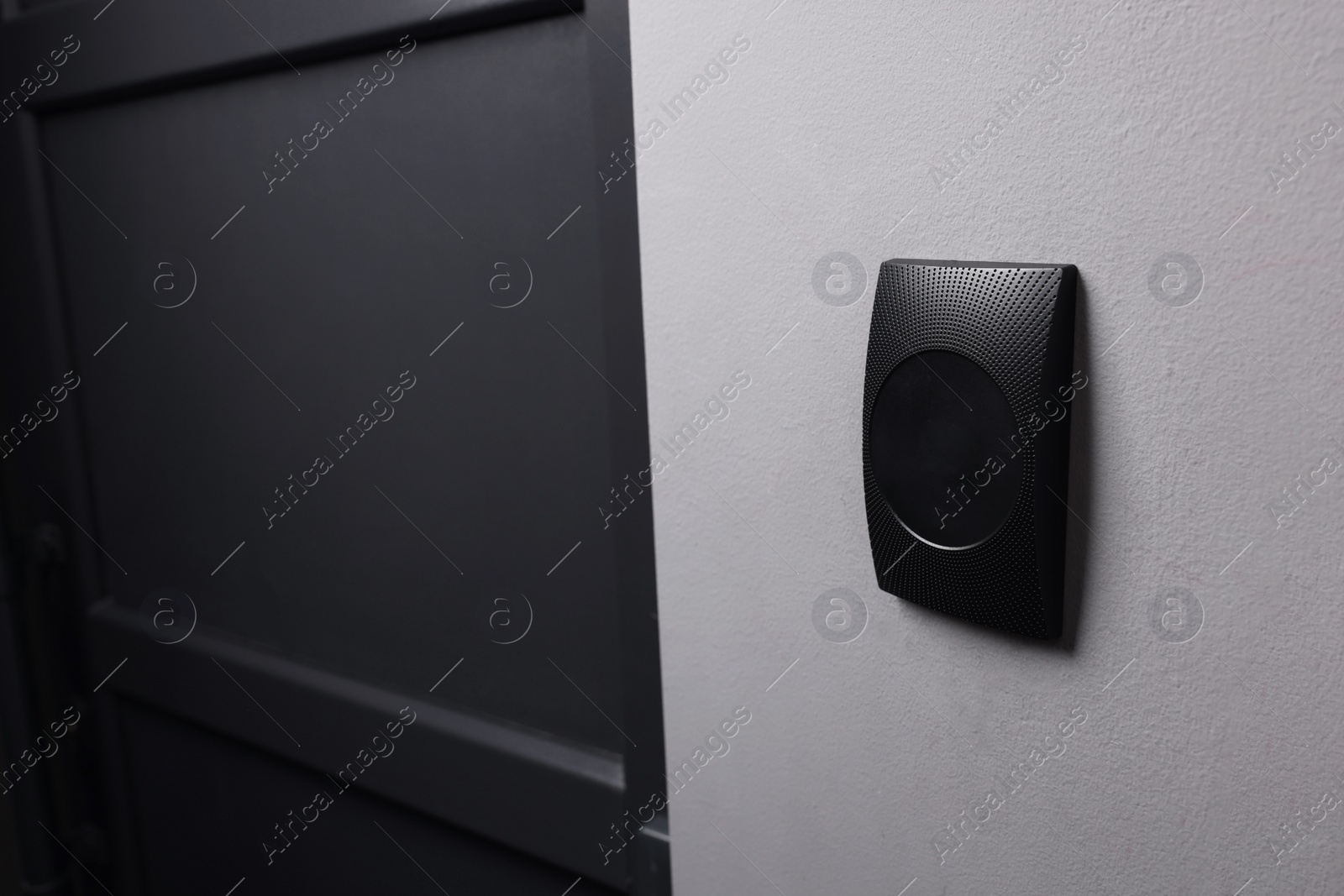 Photo of Magnetic door lock on grey wall, space for text. Home security