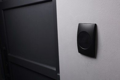 Magnetic door lock on grey wall, space for text. Home security