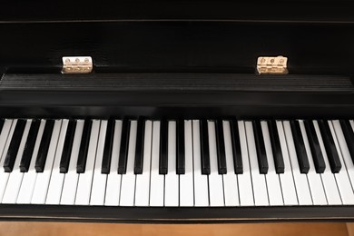 Photo of Modern piano with black and white keys, above view