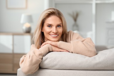 Portrait of smiling middle aged woman with blonde hair at home