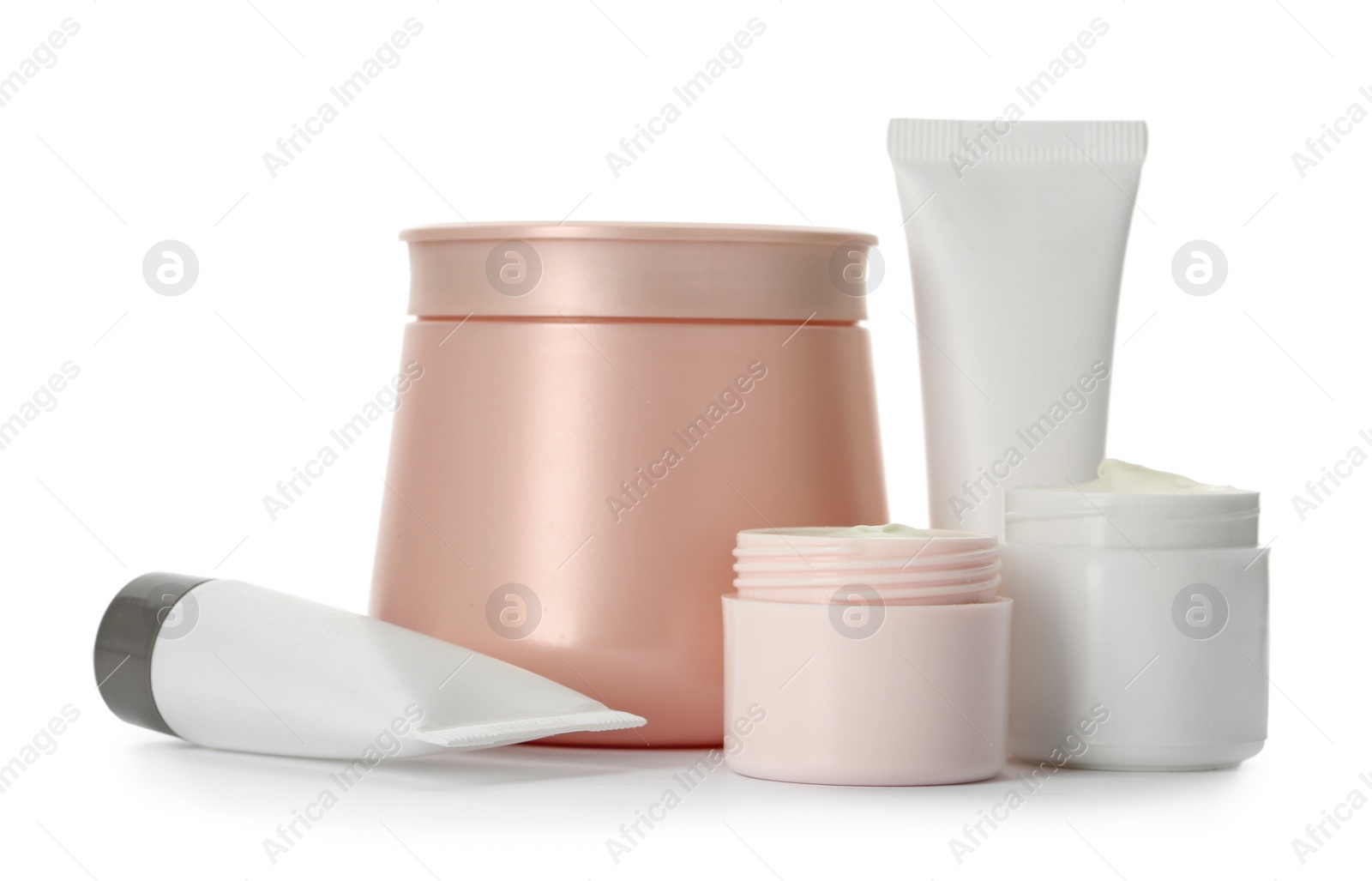 Photo of Different containers with hand cream and other cosmetic on white background