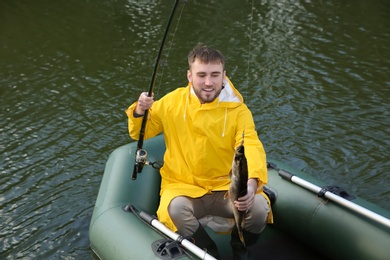 Photo of Man with rod fishing from boat. Recreational activity