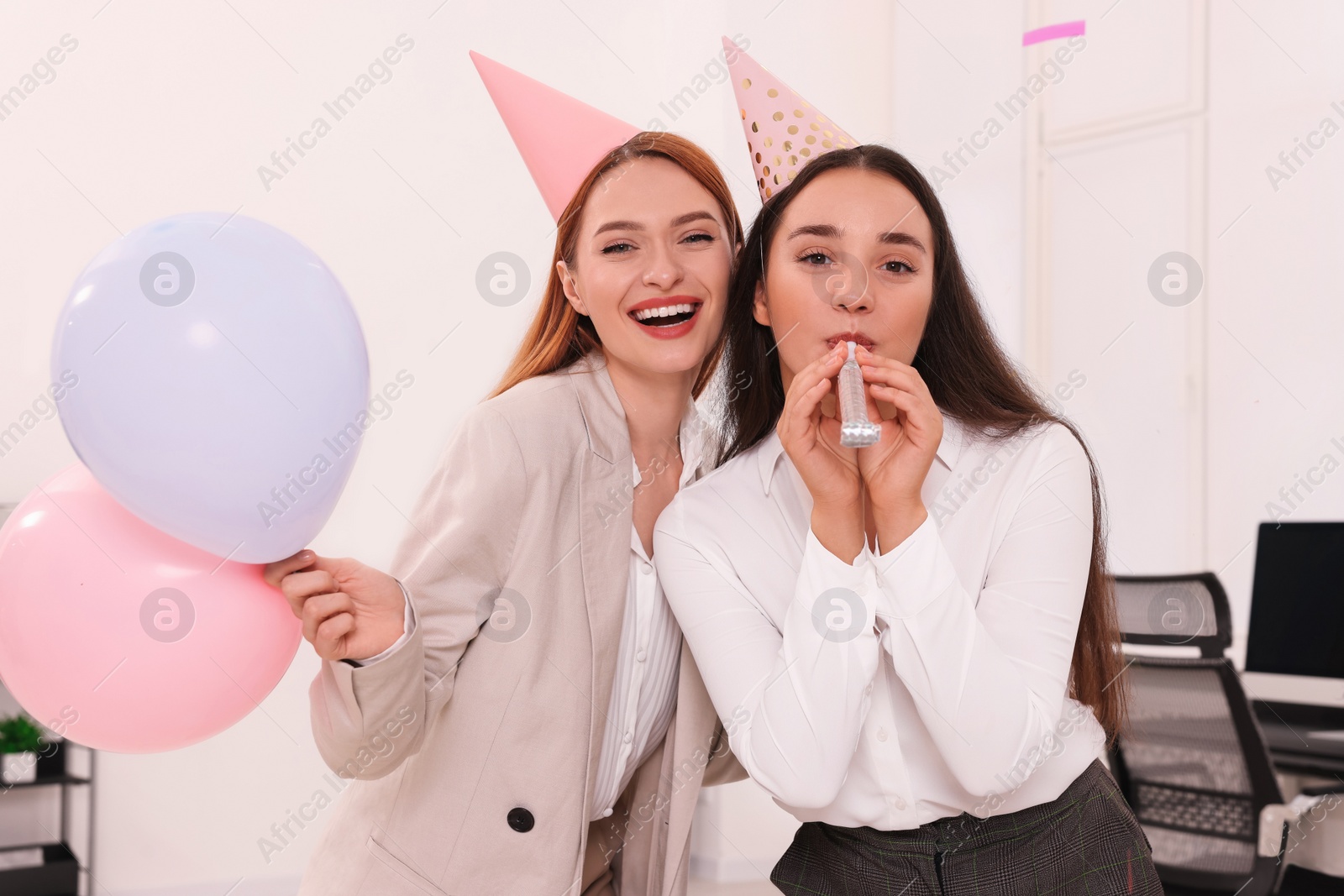 Photo of Coworkers having fun during office party indoors