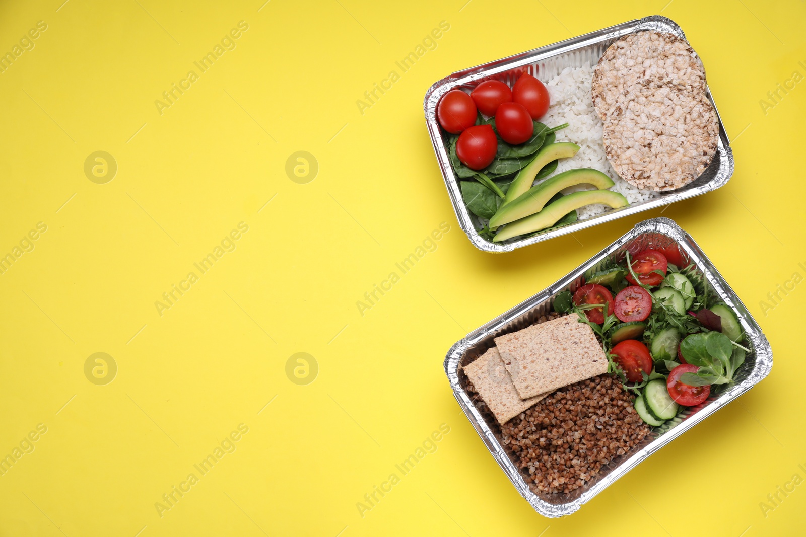 Photo of Containers with different fresh products on yellow background, flat lay. Space for text