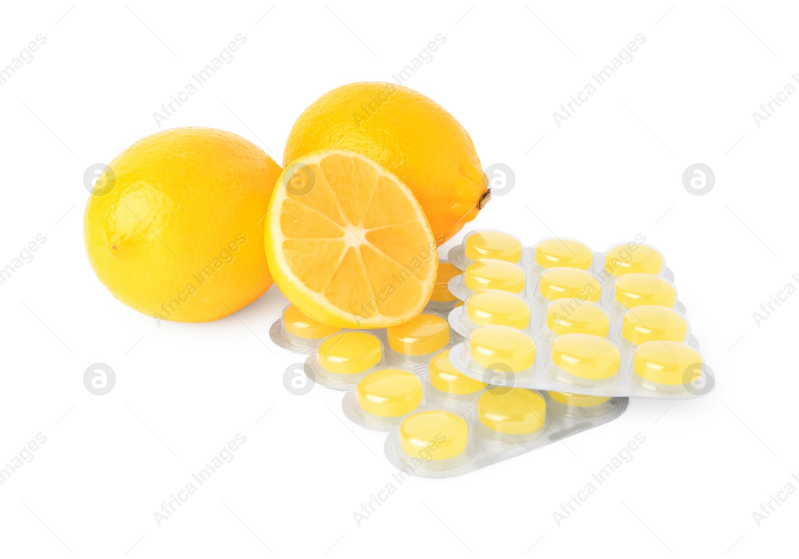 Photo of Fresh lemons and blisters with cough drops isolated on white