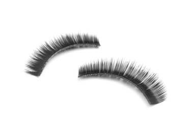 Beautiful pair of false eyelashes on white background