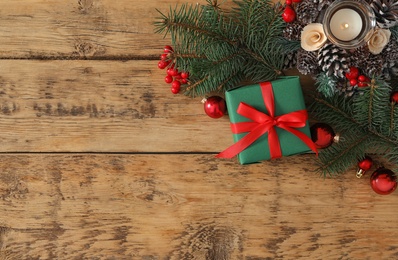 Photo of Flat lay composition with green Christmas gift box on wooden table. Space for text