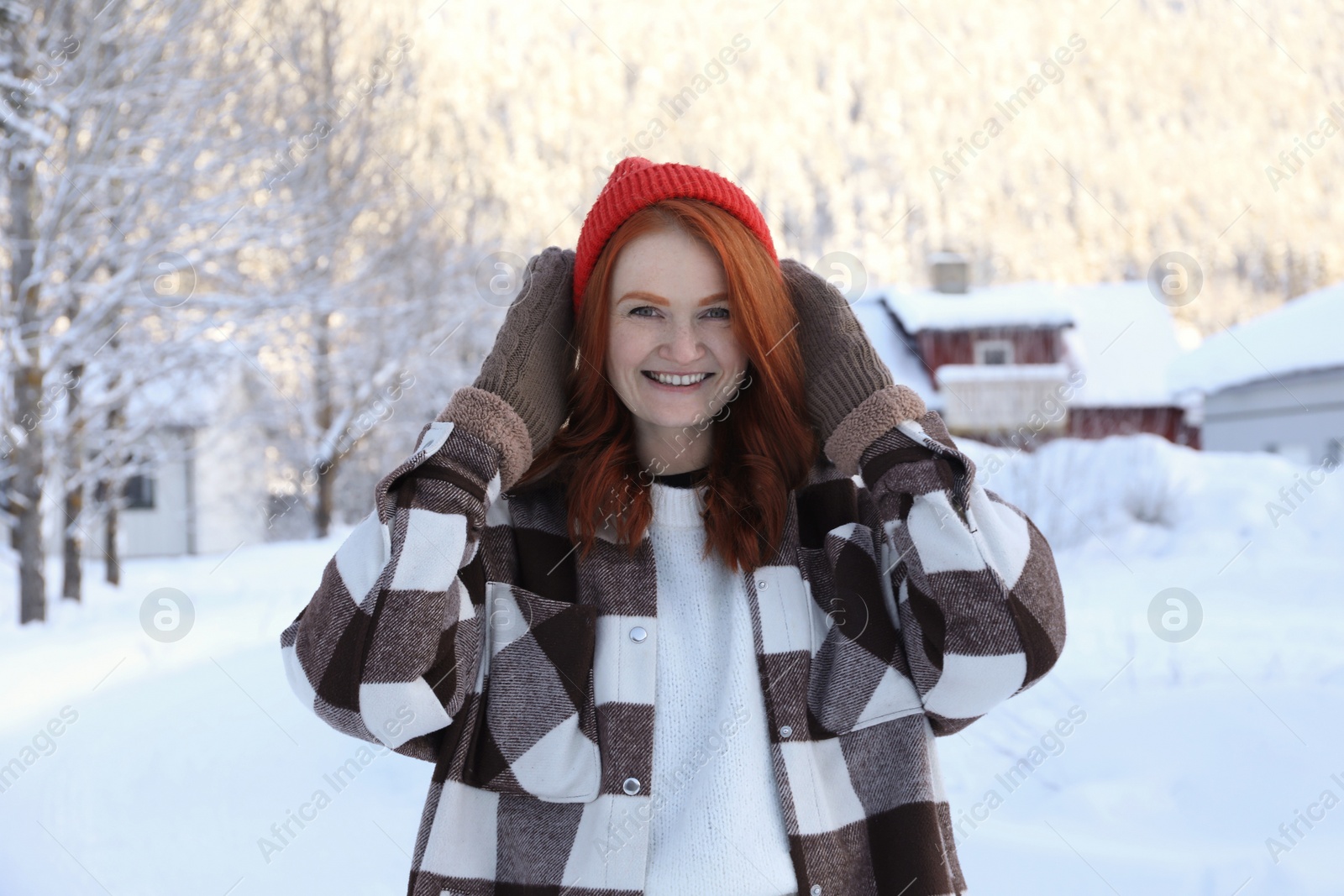 Photo of Portrait of beautiful young woman on snowy day outdoors. Winter vacation