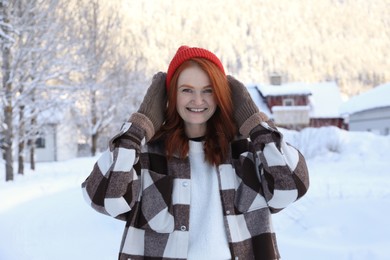 Photo of Portraitbeautiful young woman on snowy day outdoors. Winter vacation