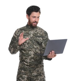 Photo of Soldier using video chat on laptop against white background. Military service