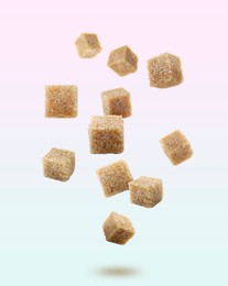 Brown cane sugar cubes falling on color gradient background