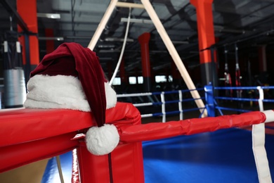 Santa hat in corner of boxing ring. Space for text