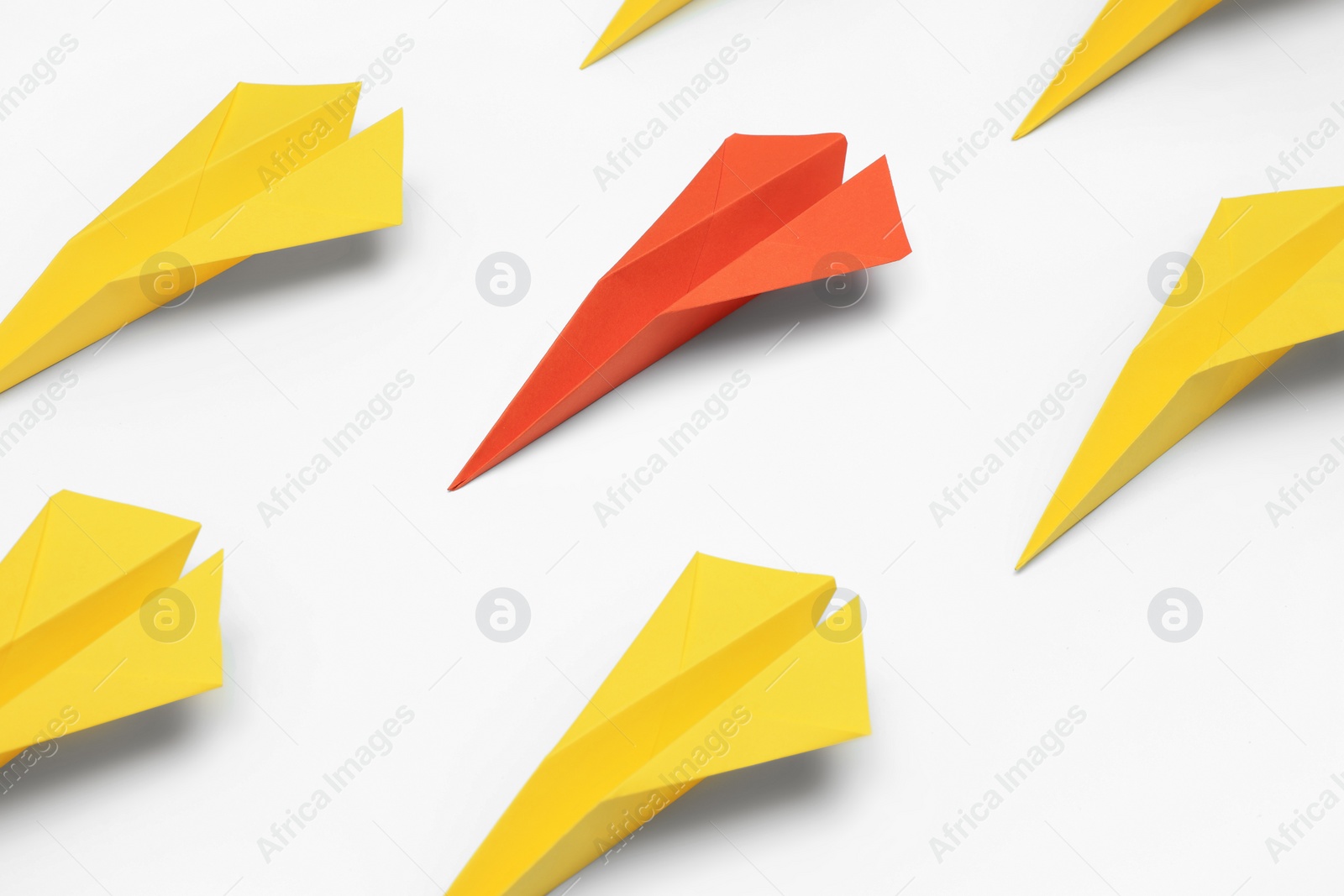 Photo of Handmade colorful paper planes on white table. Uniqueness concept