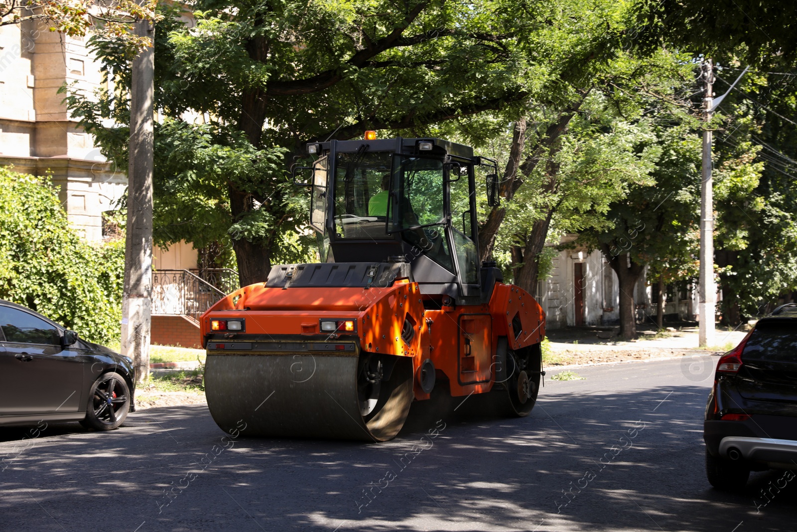 Photo of Modern roller on city street. Road repair service