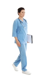 Full length portrait of female doctor in scrubs with clipboard isolated on white. Medical staff