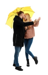 Photo of Full length portrait of beautiful couple with umbrella, isolated on white