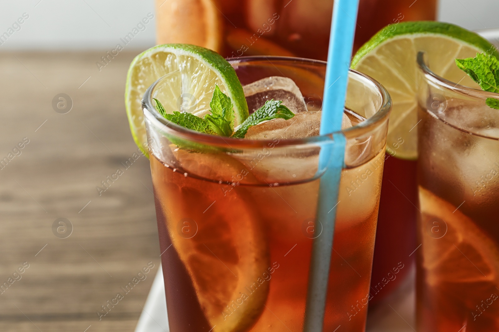 Photo of Glasses of delicious refreshing iced tea, closeup