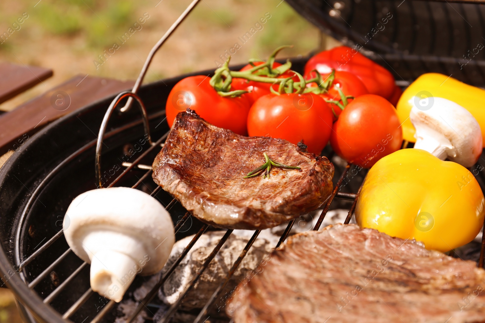 Photo of Modern grill with meat and vegetables outdoors, closeup