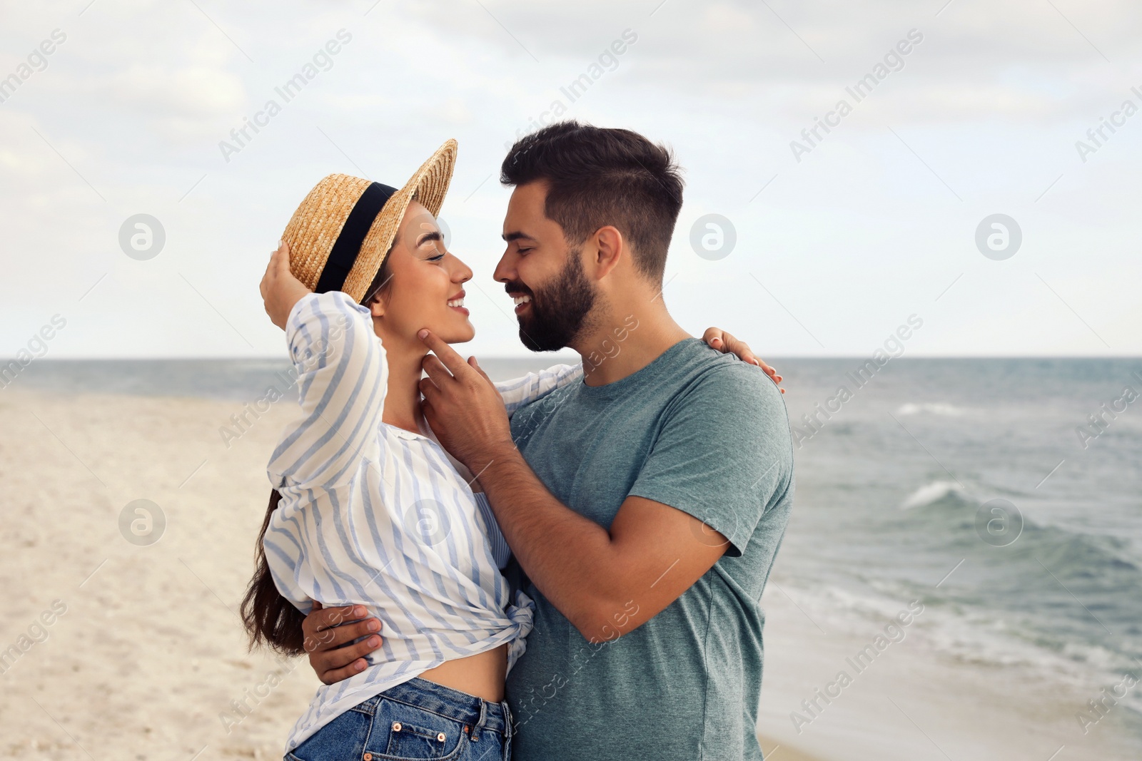 Photo of Lovely couple spending time together on beach