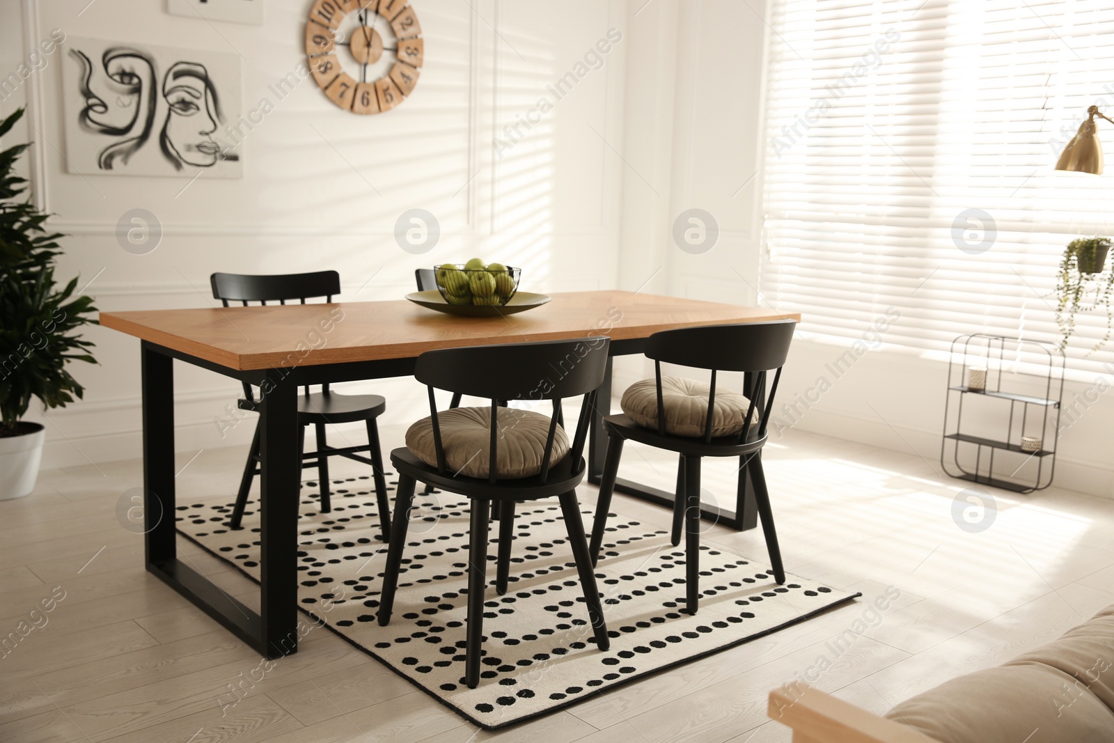 Photo of Stylish wooden dining table and chairs in room. Interior design