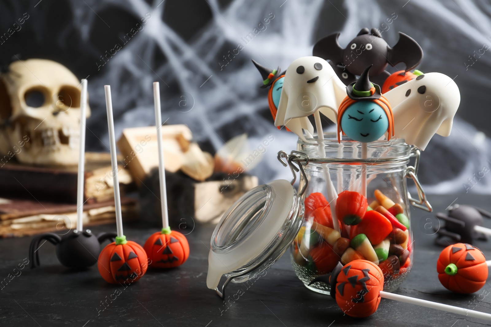 Photo of Different Halloween themed cake pops on black table