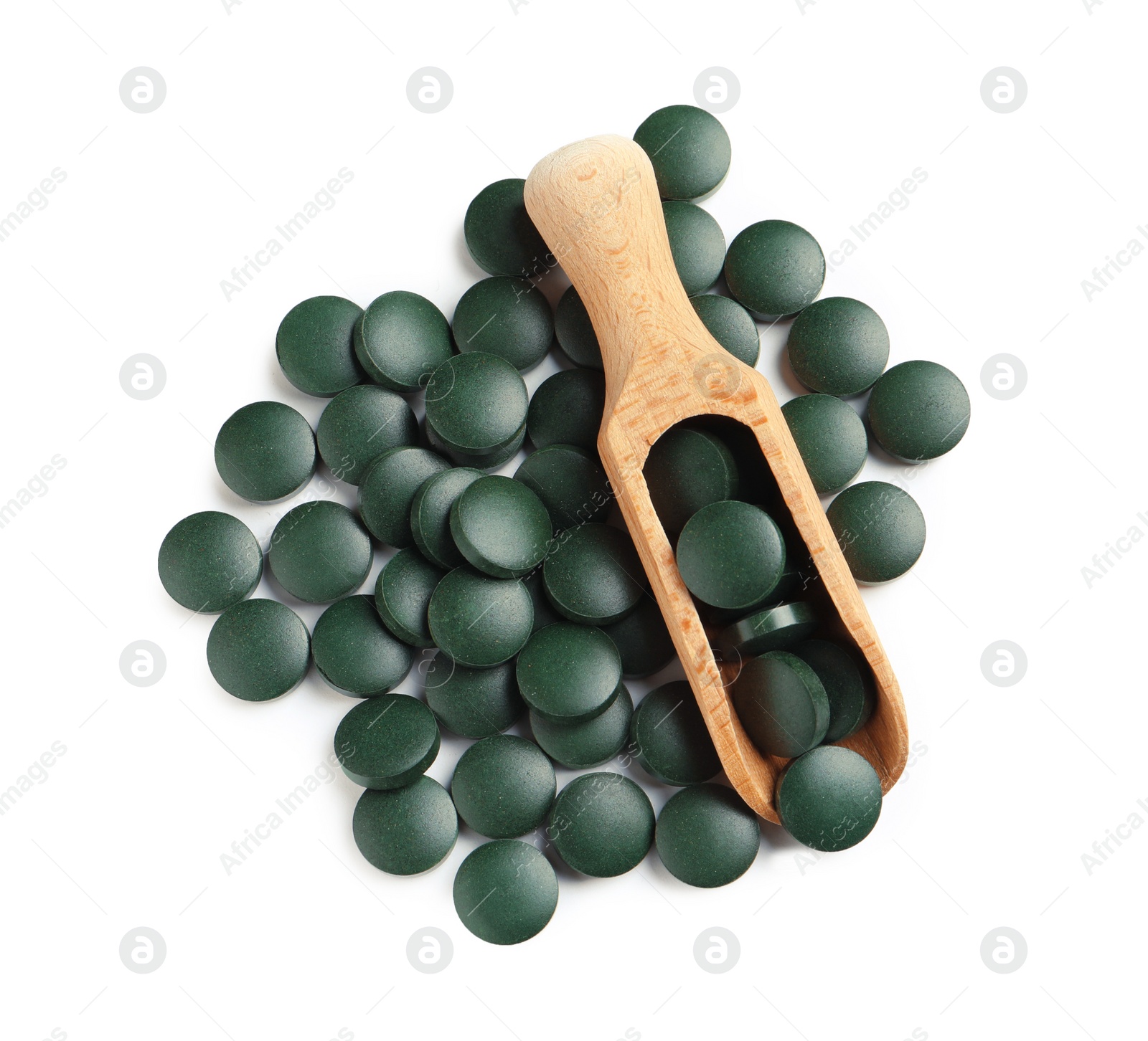 Photo of Scoop and spirulina tablets on white background, top view