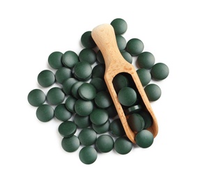 Photo of Scoop and spirulina tablets on white background, top view