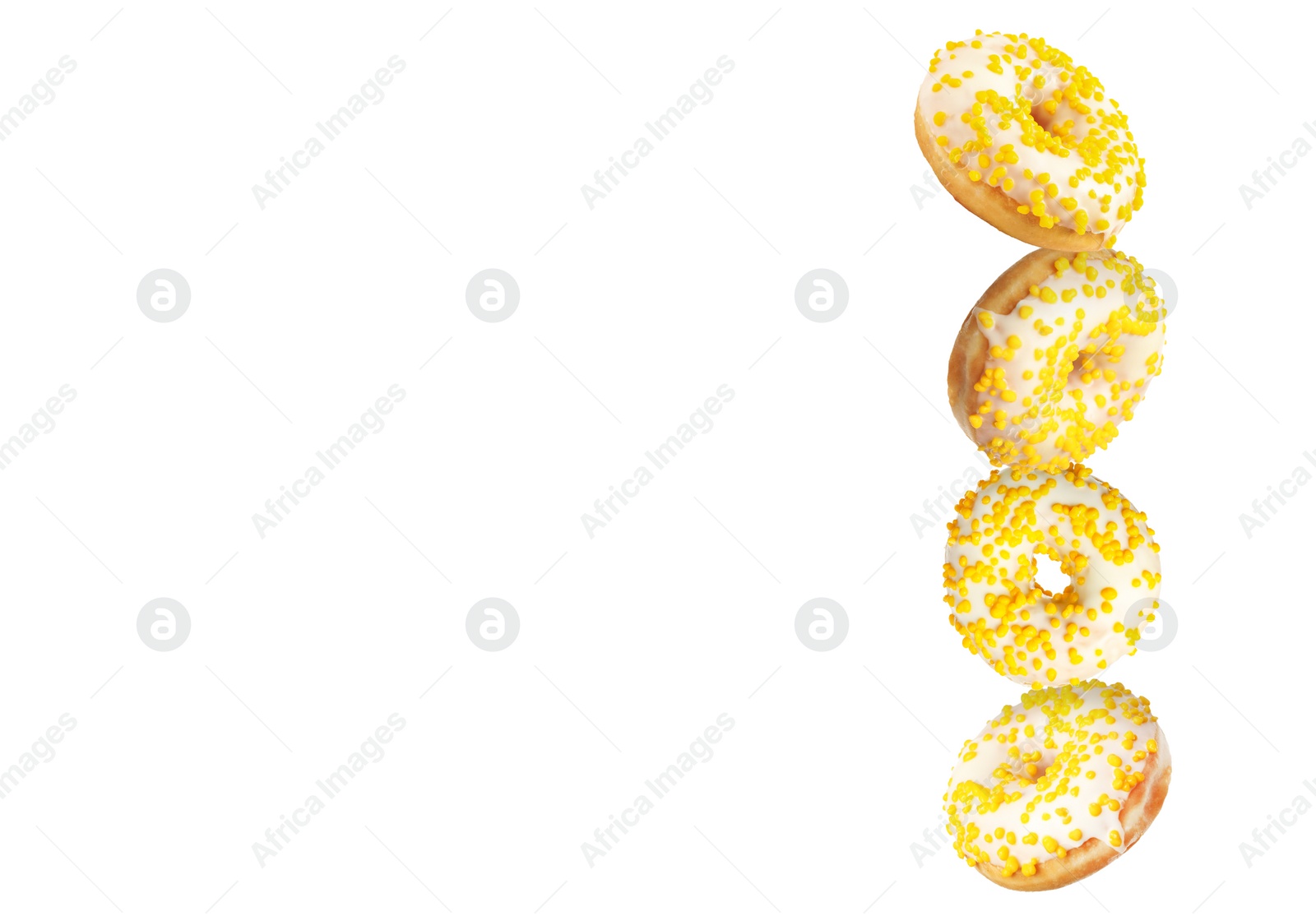Image of Tasty donuts with sprinkles falling on white background