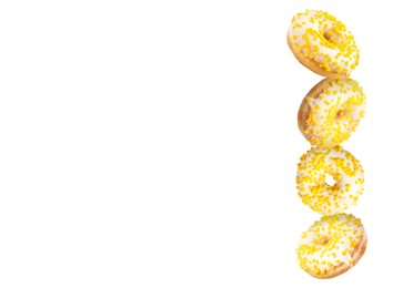 Tasty donuts with sprinkles falling on white background