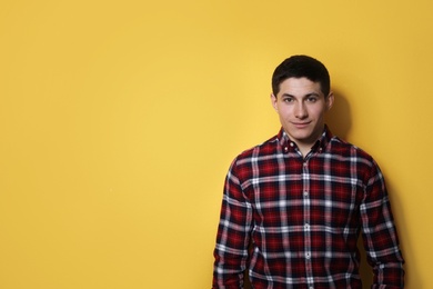 Portrait of young handsome man on color background, space for text