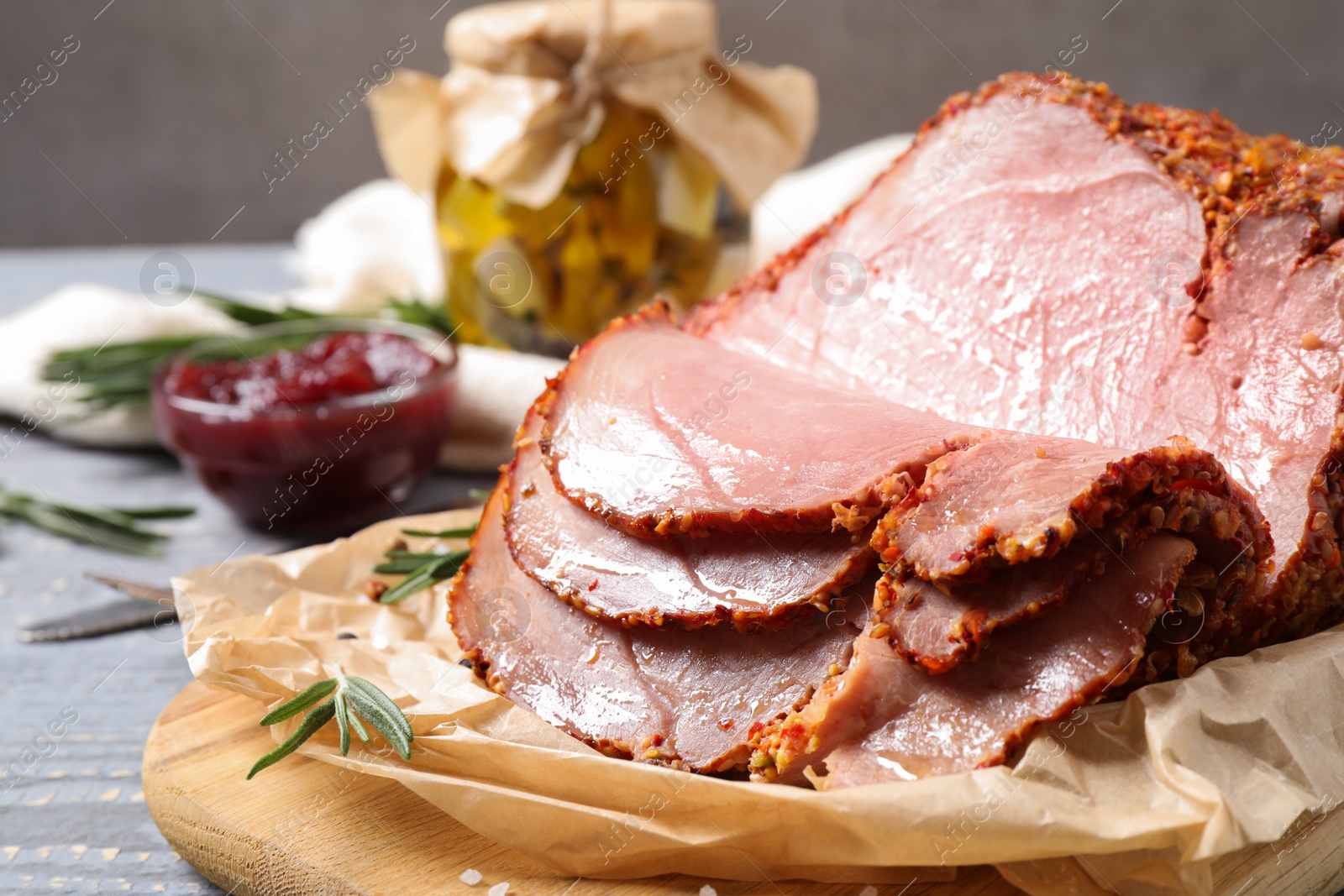 Photo of Delicious cooked ham served on wooden board, closeup