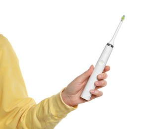 Photo of Woman holding electric toothbrush on white background, closeup