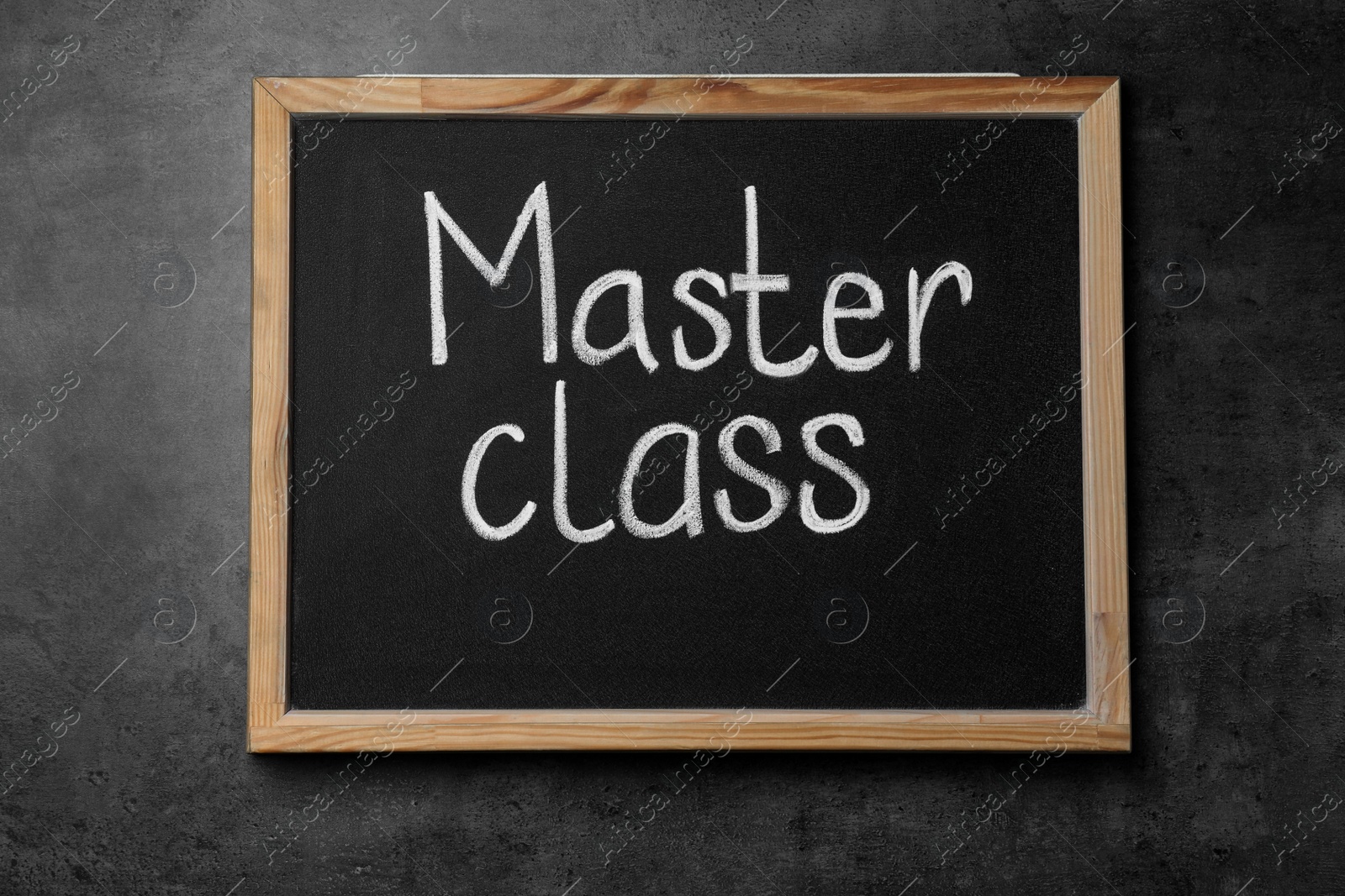 Photo of Blackboard with words Master Class on grey table, top view