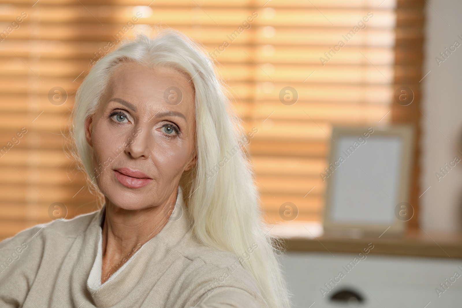 Photo of Portrait of elegant mature woman at home. Space for text