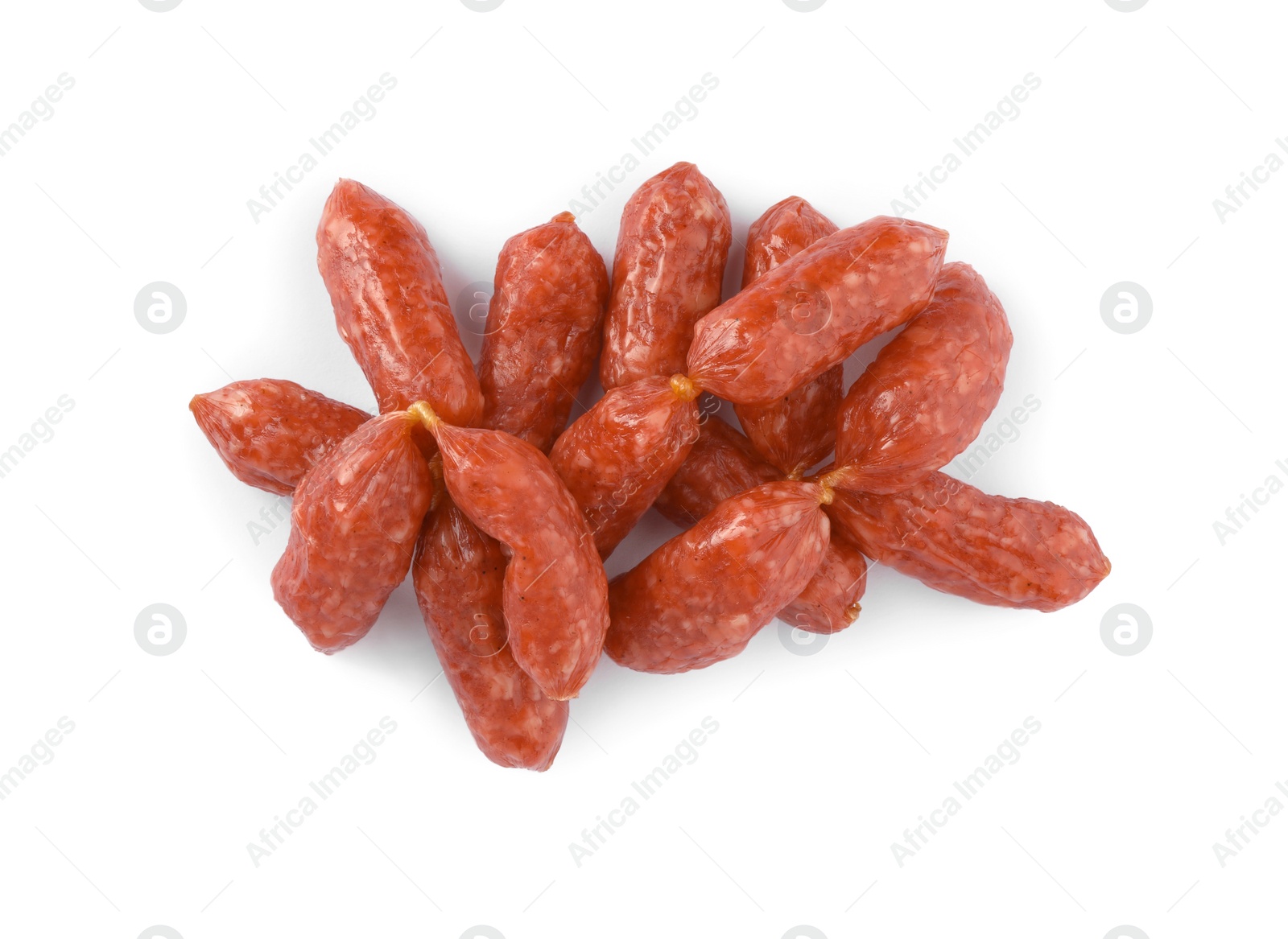 Photo of Thin dry smoked sausages isolated on white, top view