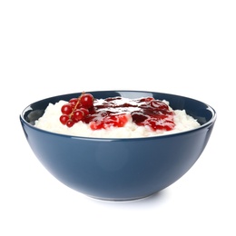 Creamy rice pudding with red currant and jam in bowl on white background