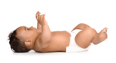 Photo of Adorable African-American baby in diaper on white background