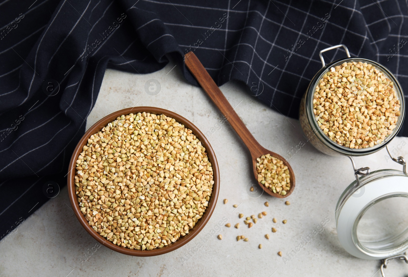 Photo of Uncooked green buckwheat grains on table, flat lay